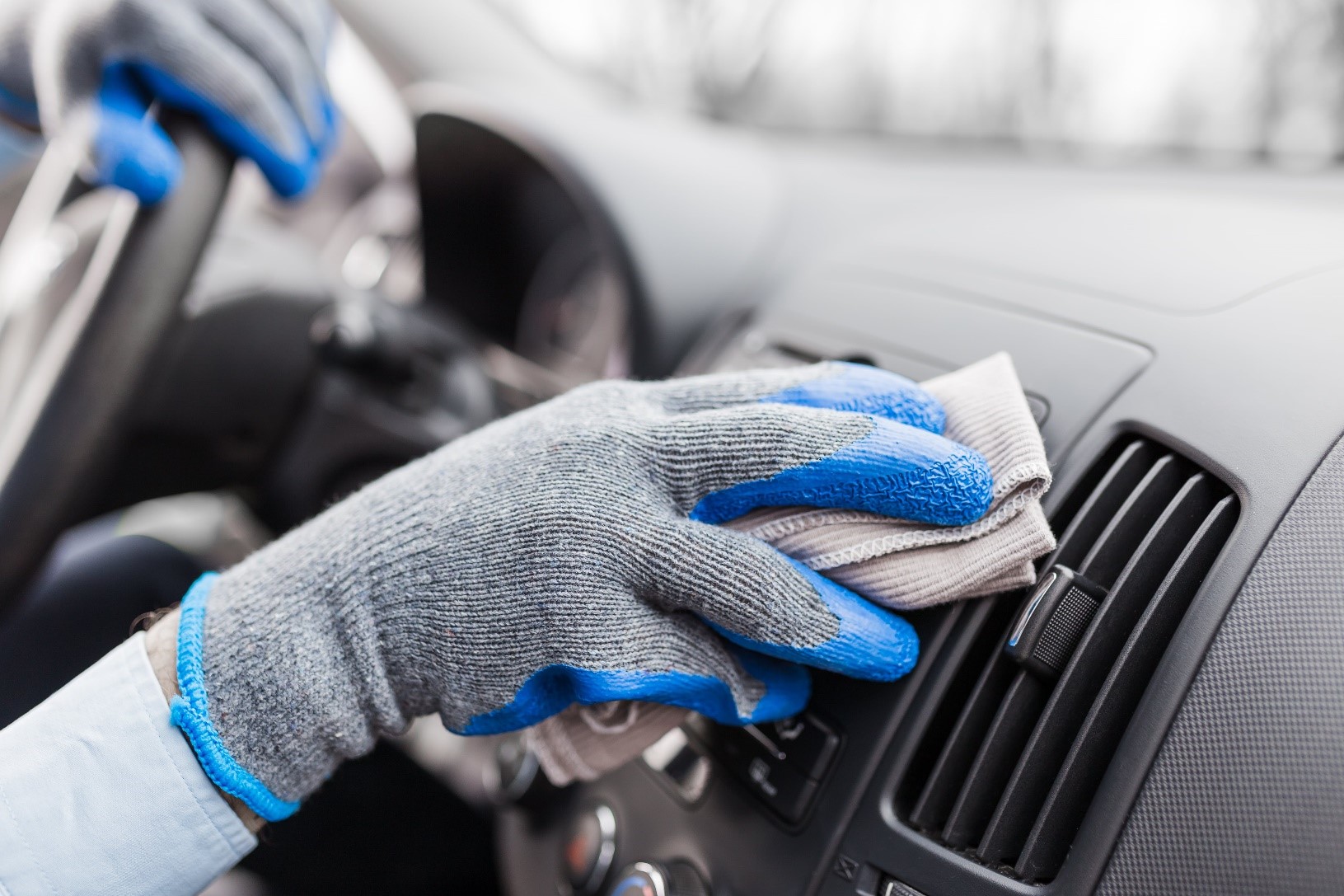 Person cleaning the interior of a car